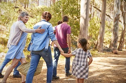 Extended family walking on wooded path