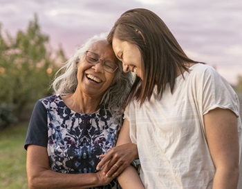 older woman with caregiver outside